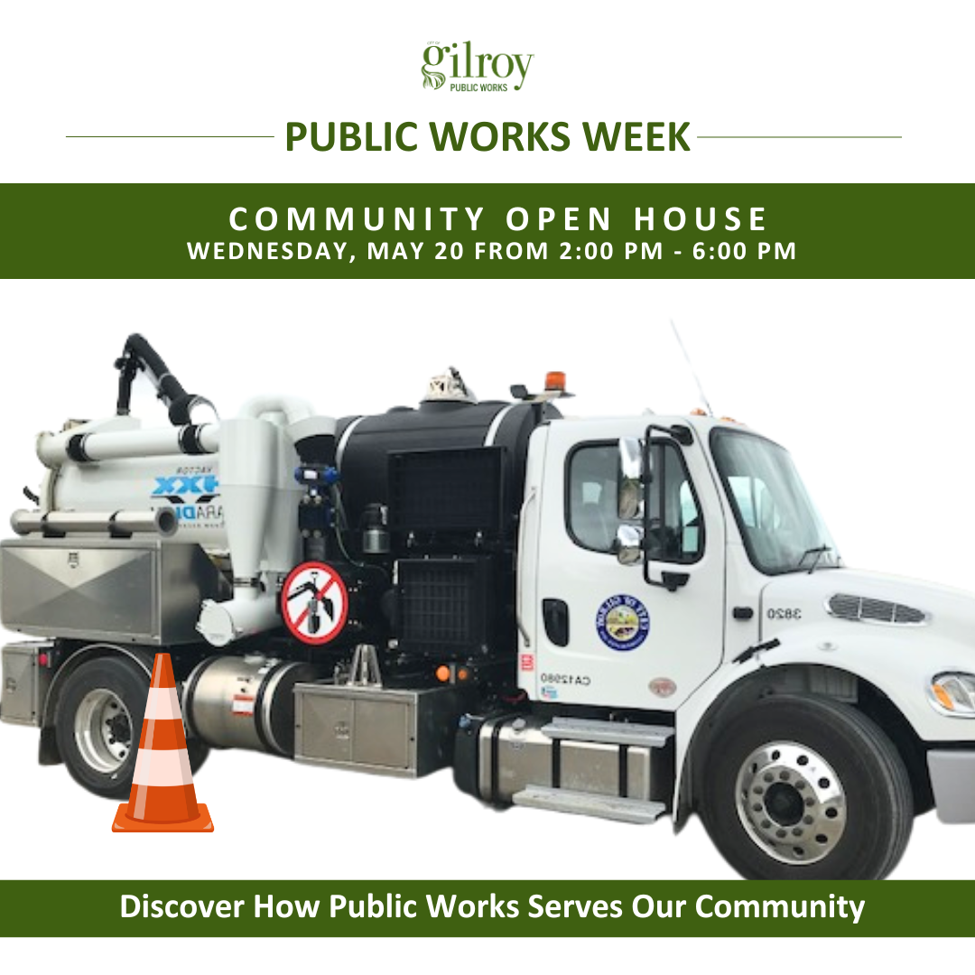 White public works truck with city seal and orange traffic cone in front